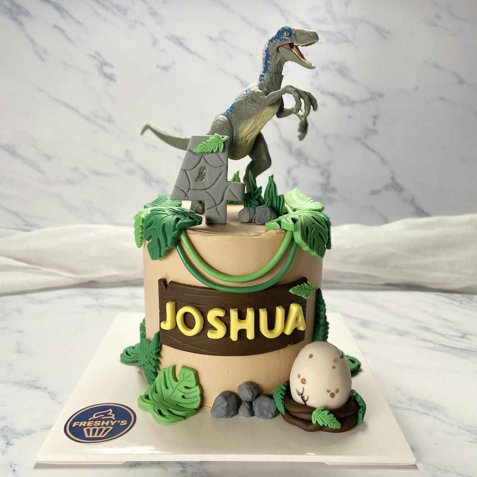 Fondant sculpted dinosaur cake